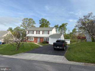 12206 Maycheck Lane Bowie, MD 20715 - Photo 3 of 19 a car parked in front of a house next to a yard