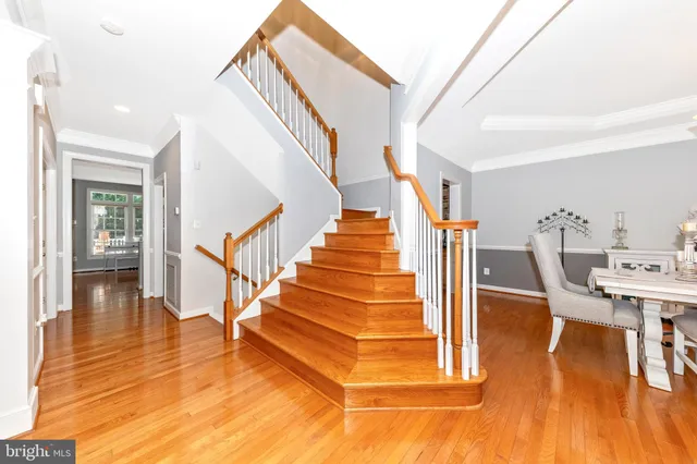 a view of entryway and hall with wooden floor
