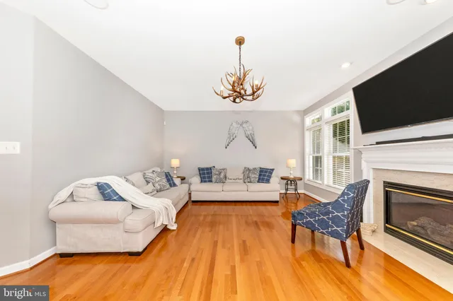 a living room with fireplace furniture and a flat screen tv