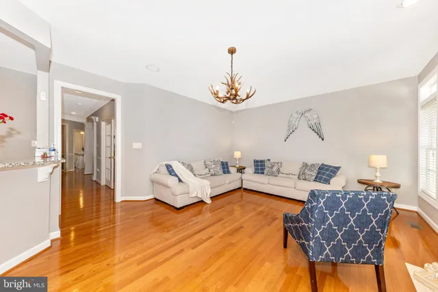 a living room with furniture and a chandelier