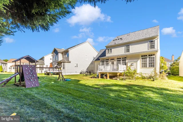 a view of a house with a big yard and potted plants