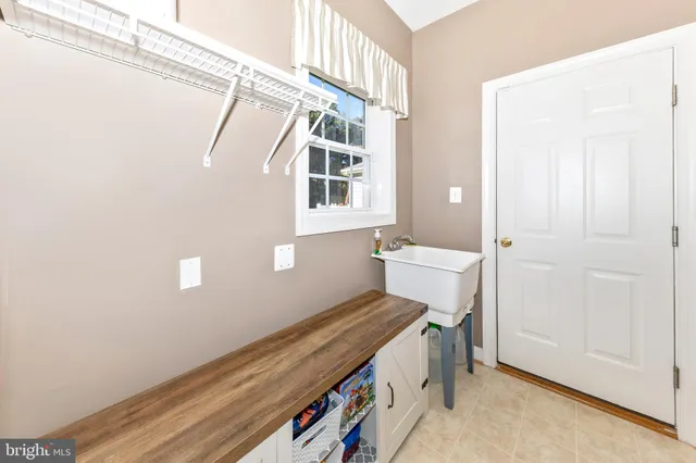 a kitchen with stainless steel appliances granite countertop wooden cabinets a sink and a stove