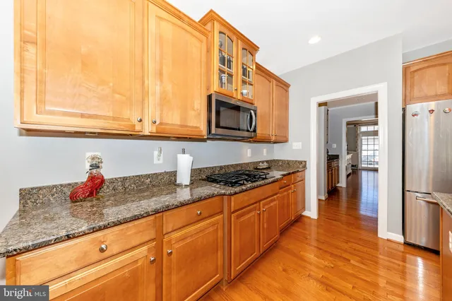 a view of a dining room with furniture a chandelier and wooden floor