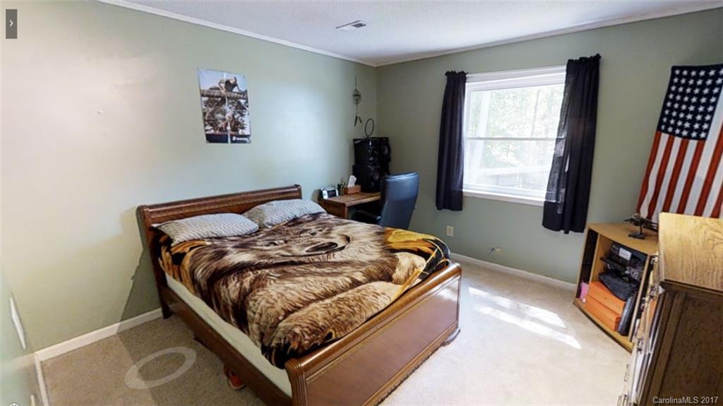 1606 Windsong Forest Road Clover, SC 29710 - Photo 11 of 15 a bed sitting in a bedroom next to a window