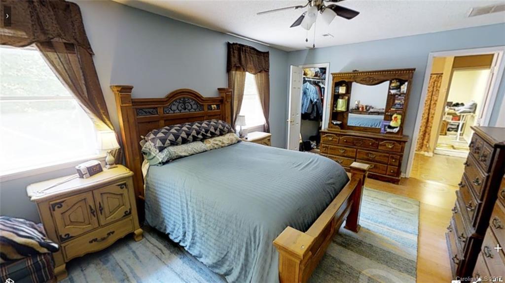 1606 Windsong Forest Road Clover, SC 29710 - Photo 15 of 15 a bedroom with a bed and a chandelier