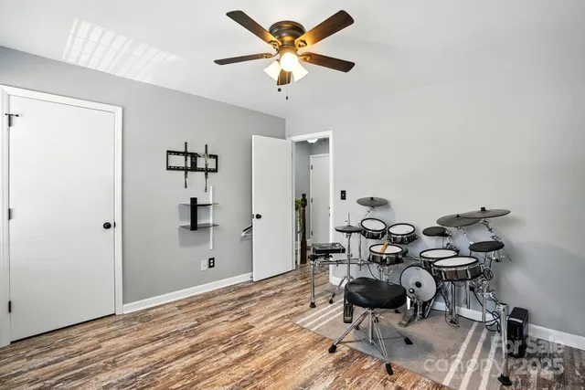 a view of a workspace with furniture and wooden floor