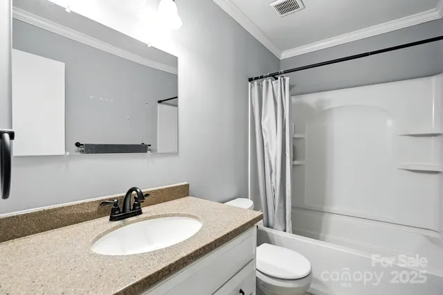 a bathroom with a sink toilet a mirror and shower