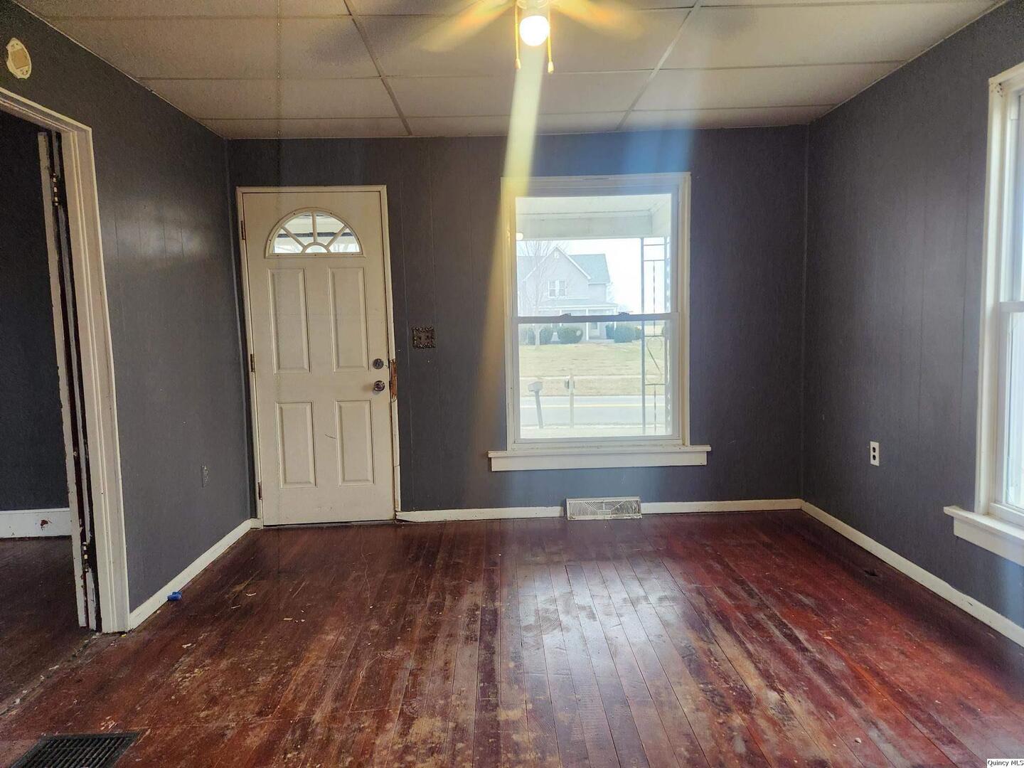 413 South Main Street Loraine, IL 62349 - Photo 4 of 4 an empty room with wooden floor and windows
