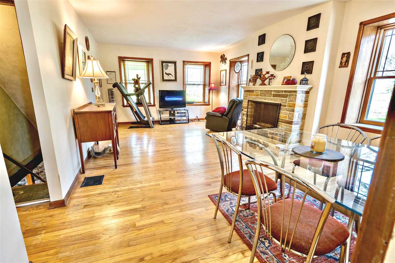 4295 Shattuck Road Garden Prairie, IL 61038 - Photo 6 of 20 a living room with furniture a flat screen tv and a floor to ceiling window
