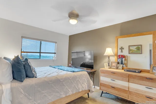 a bedroom with a large bed and a window