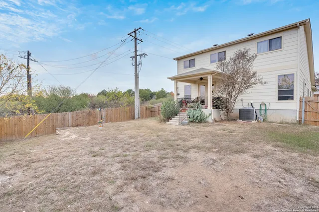 a view of a house with a yard and potted plants