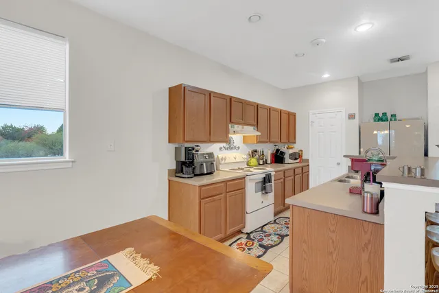 a kitchen with a sink cabinets and window