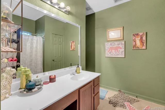 a bathroom with a sink vanity and a mirror