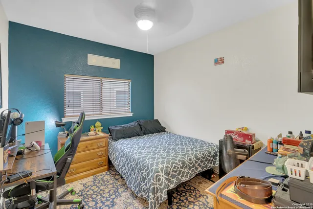 a bedroom with two beds and a wooden floor