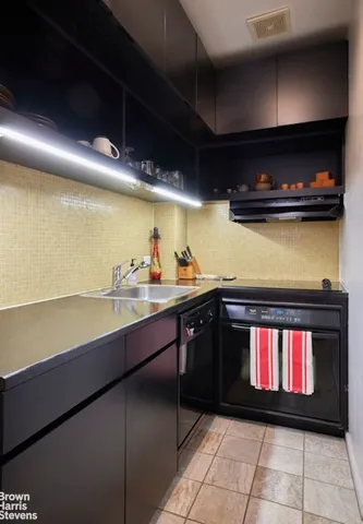 a kitchen with stainless steel appliances a stove and cabinets
