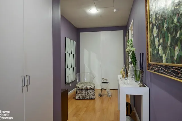 a hallway with a dining table and chandelier