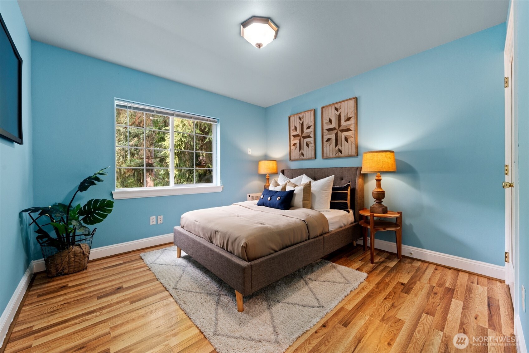 7331 151st Avenue Northeast, Unit B Redmond, WA 98052 - Photo 12 of 20 a bedroom with a bed table window and a potted plant