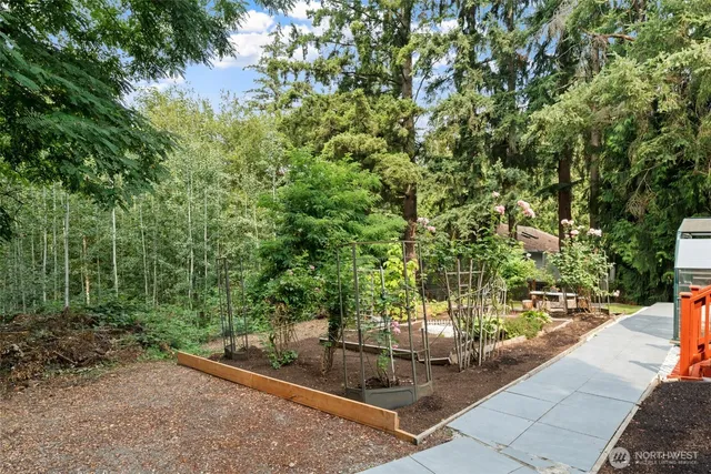 a view of a house with backyard sitting area and garden