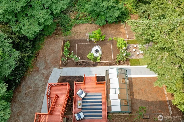 an aerial view of a house with a yard and garden