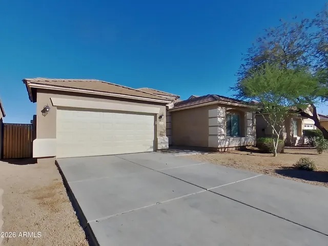 a view of garage with a car parked in front of it