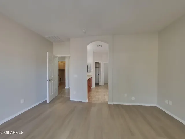 an empty room with wooden floor and sliding door