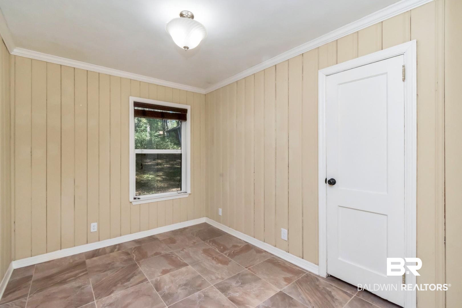 410 St John Place Mobile, AL 36609 - Photo 21 of 32 Empty room featuring crown molding and wood walls