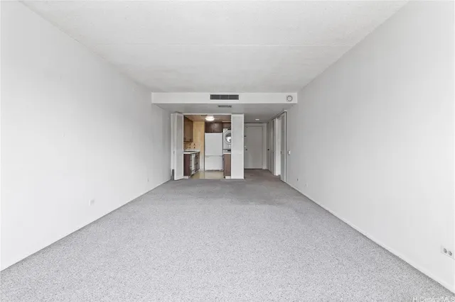 a view of a kitchen with refrigerator and white cabinets