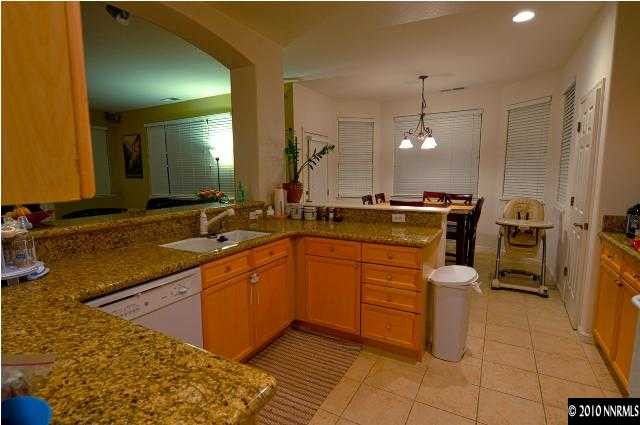 1730 Ornellaia Way Reno, NV 89521 - Photo 4 of 12 a kitchen with stainless steel appliances granite countertop a sink stove and refrigerator