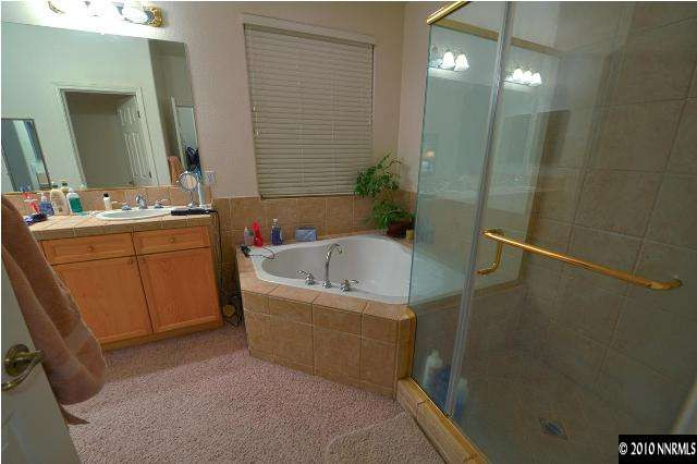 1730 Ornellaia Way Reno, NV 89521 - Photo 9 of 12 a bathroom with a tub sink and mirror