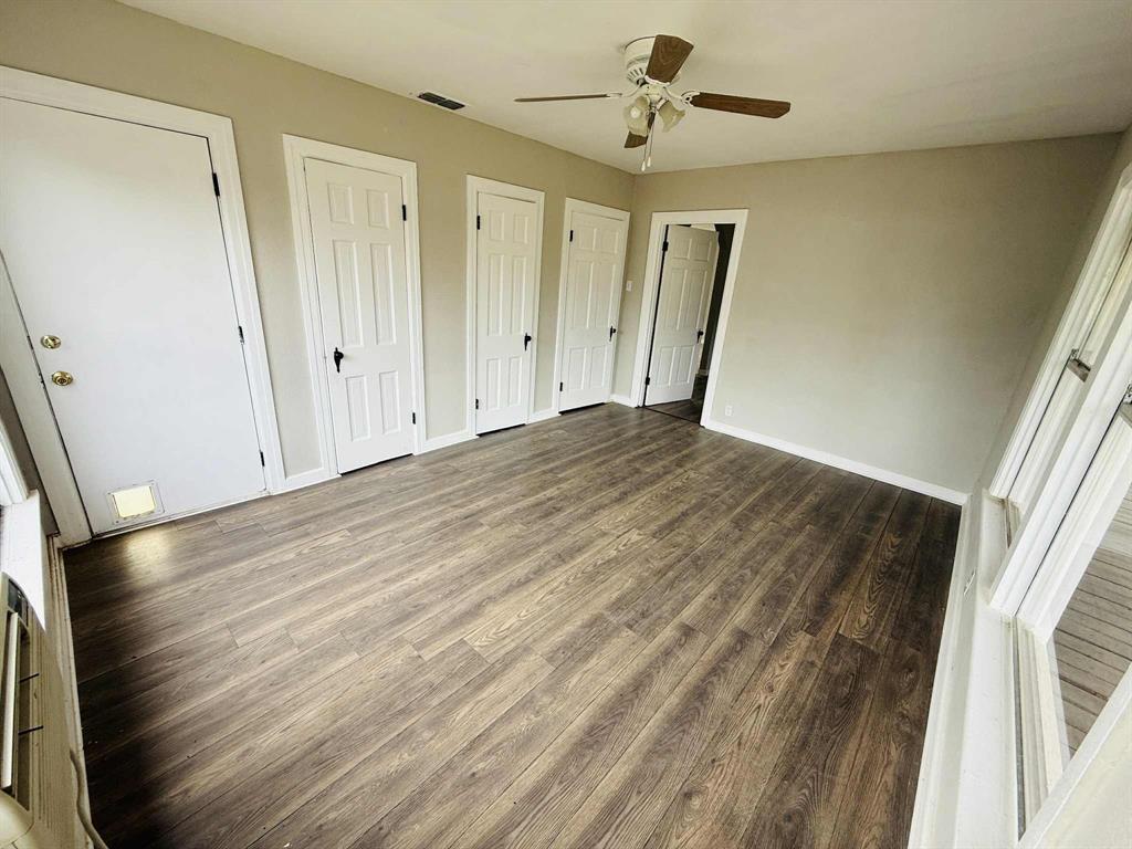 209 Hollywood Street Coleman, TX 76834 - Photo 14 of 19 a view of empty room with wooden floor and fan