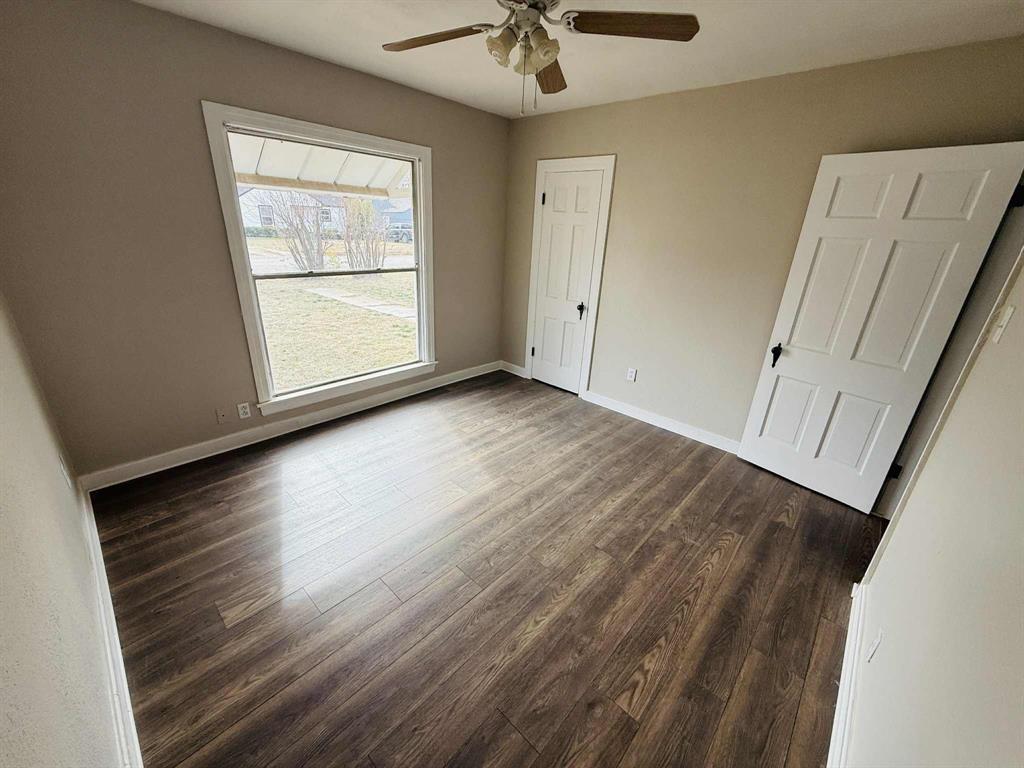 209 Hollywood Street Coleman, TX 76834 - Photo 17 of 19 wooden floor in an empty room with a window