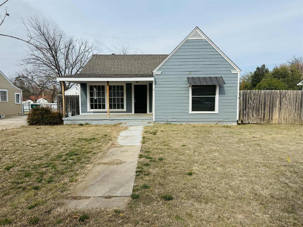209 Hollywood Street Coleman, TX 76834 - Photo 2 of 19 a front view of a house with a garden