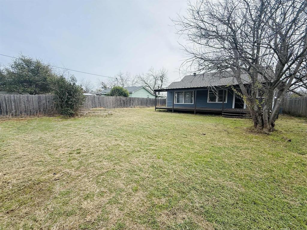 209 Hollywood Street Coleman, TX 76834 - Photo 7 of 19 a view of a house with a yard