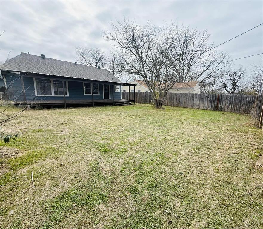 209 Hollywood Street Coleman, TX 76834 - Photo 8 of 19 a front view of a house with a large space