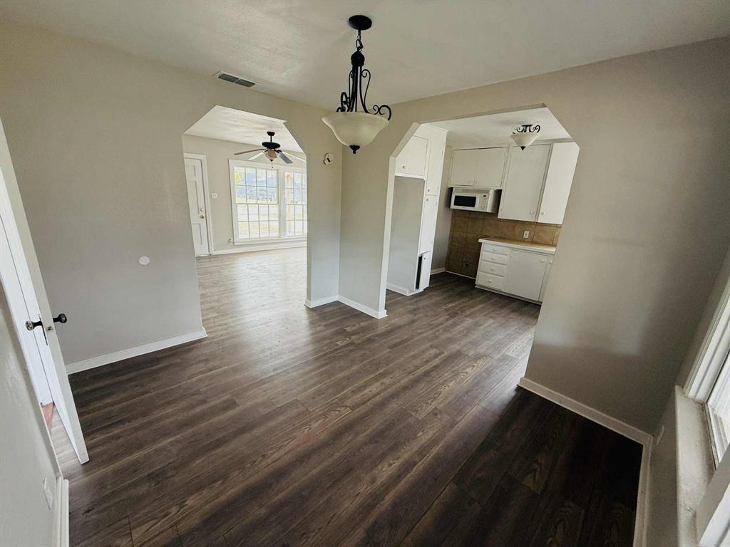 209 Hollywood Street Coleman, TX 76834 - Photo 10 of 19 workspace with wooden floor and windows