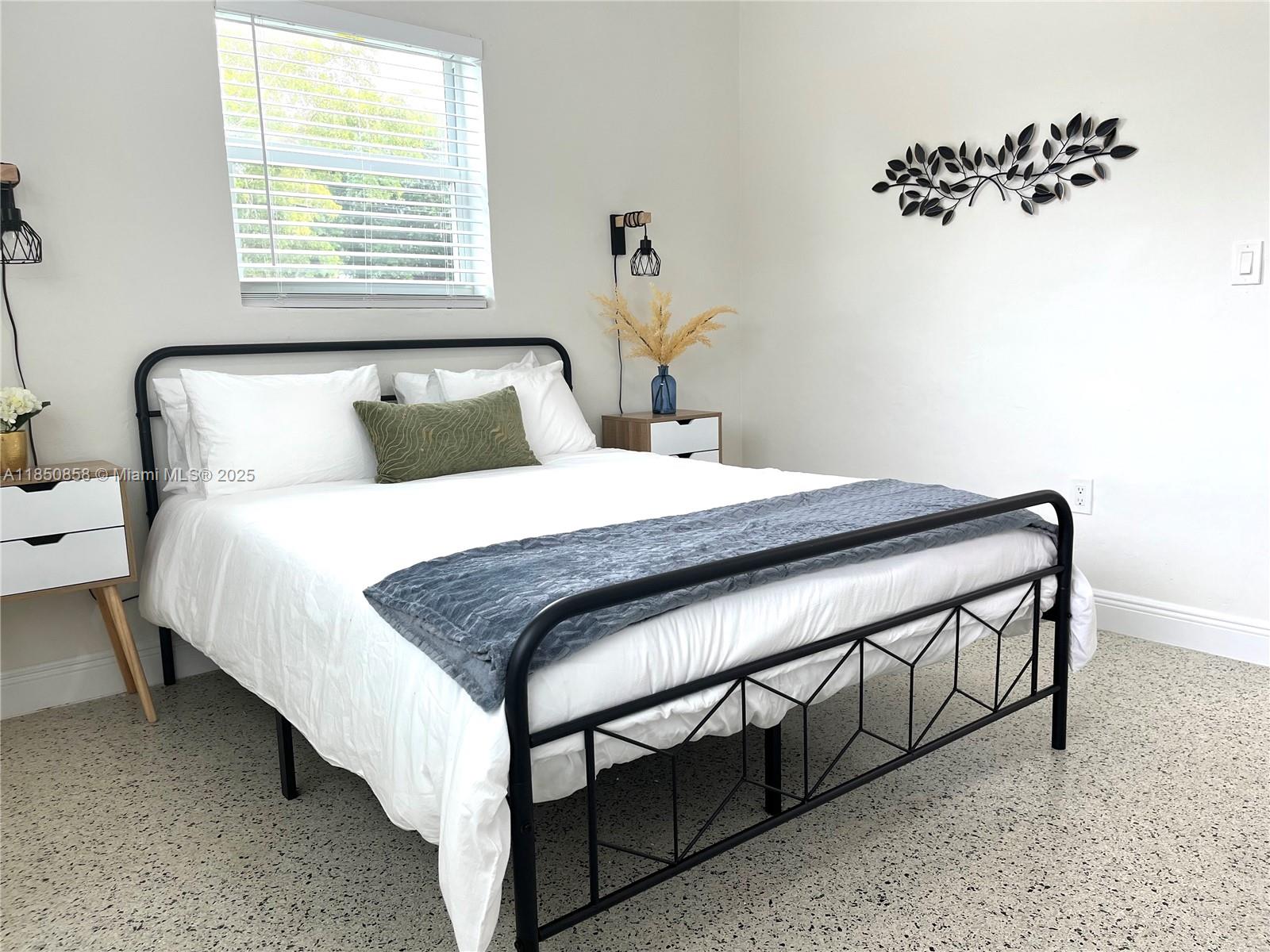 Westside Miami, FL 33167 - Photo 16 of 19 a bedroom with a bed and a window