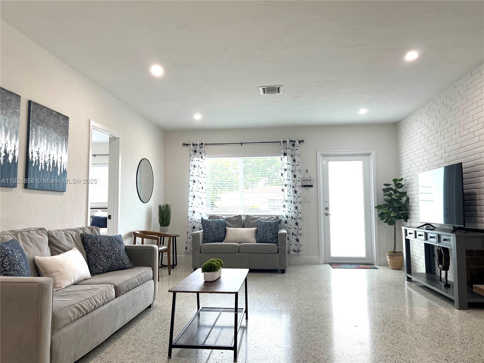 Westside Miami, FL 33167 - Photo 6 of 19 a living room with furniture and a large window