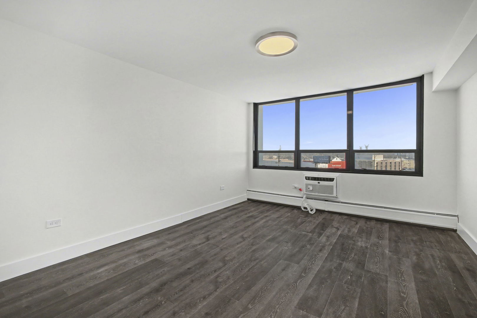 8801 West Golf Road, Unit 6E Niles, IL 60714 - Photo 12 of 15 an empty room with wooden floor and window