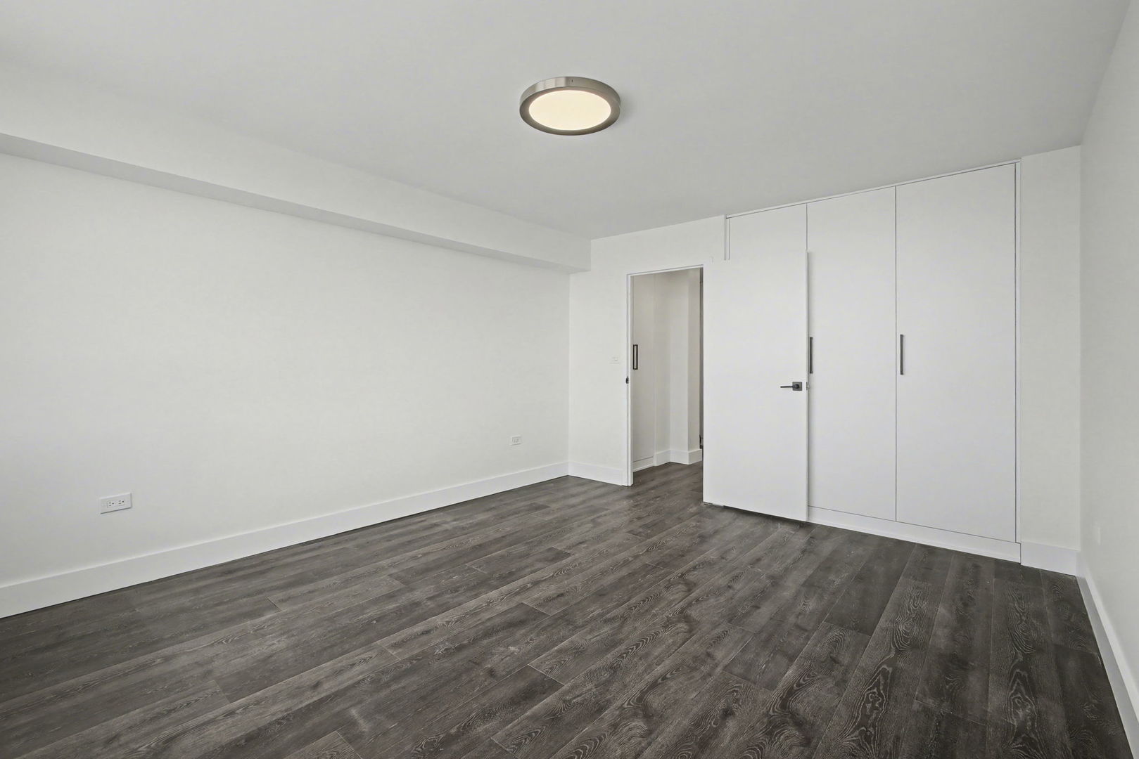 8801 West Golf Road, Unit 6E Niles, IL 60714 - Photo 13 of 15 a view of an empty room with wooden floor and window