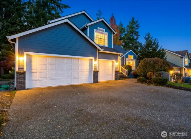 a view of a house with a yard and garage