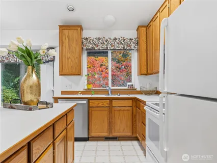 a kitchen with a sink window and cabinets