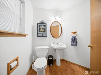 a bathroom with a toilet a sink and a mirror