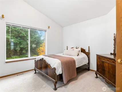 a bed sitting in a room next to a window