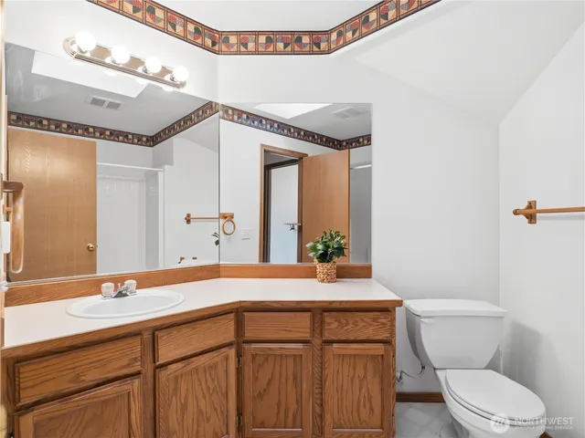a bathroom with a sink a toilet and mirror