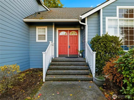a front view of a house with a garden