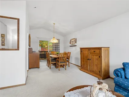 a dining room with furniture and wooden floor