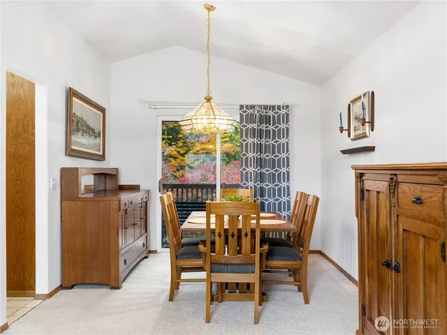 a view of a dining room with furniture and chandelier