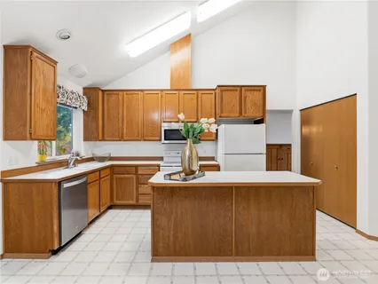 a kitchen with stainless steel appliances a sink and a refrigerator