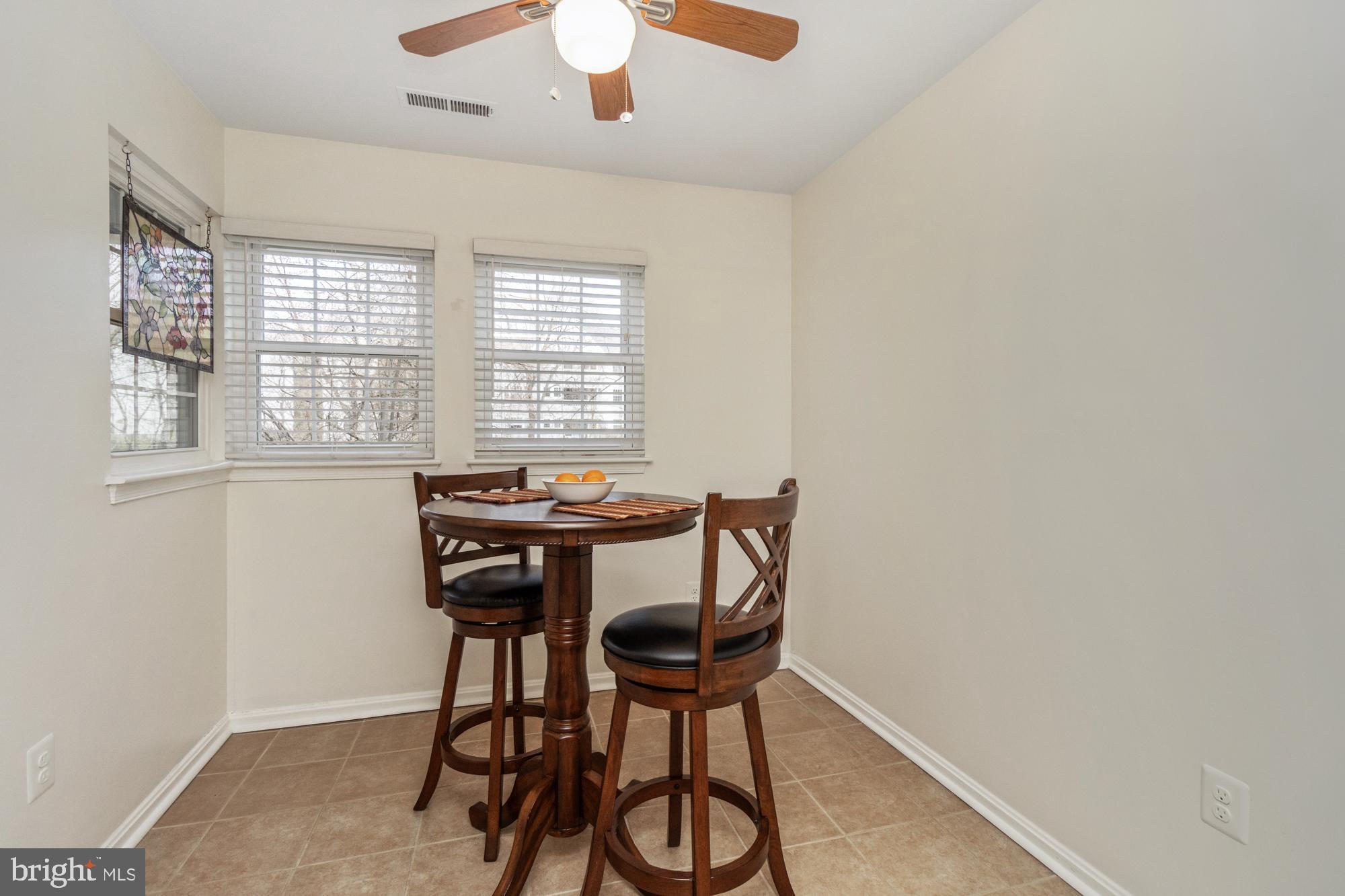 8489 Falls Run Road, Unit B Ellicott City, MD 21043 - Photo 13 of 41 a view of a dining room with furniture and window