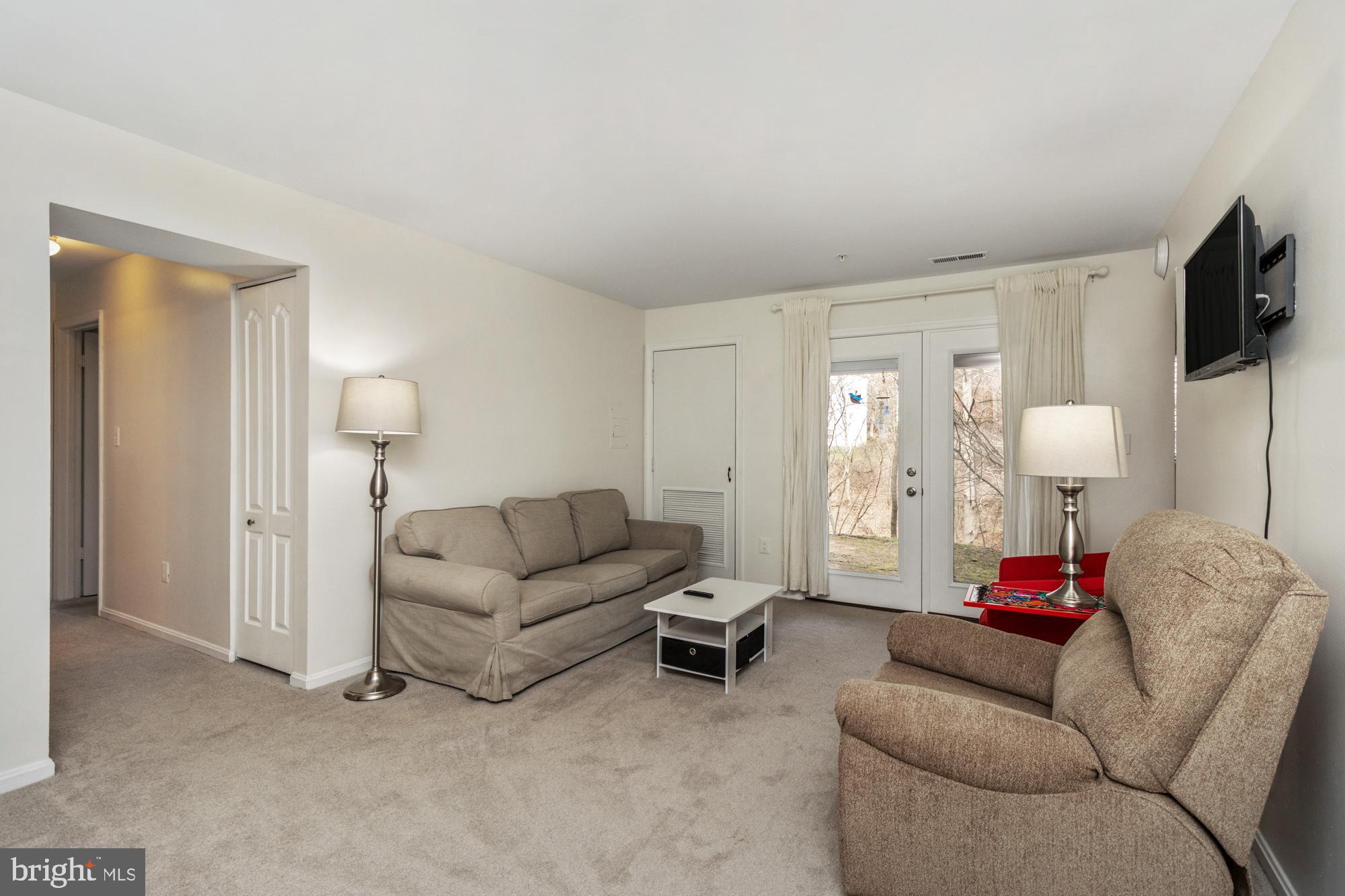 8489 Falls Run Road, Unit B Ellicott City, MD 21043 - Photo 16 of 41 a living room with furniture and a flat screen tv